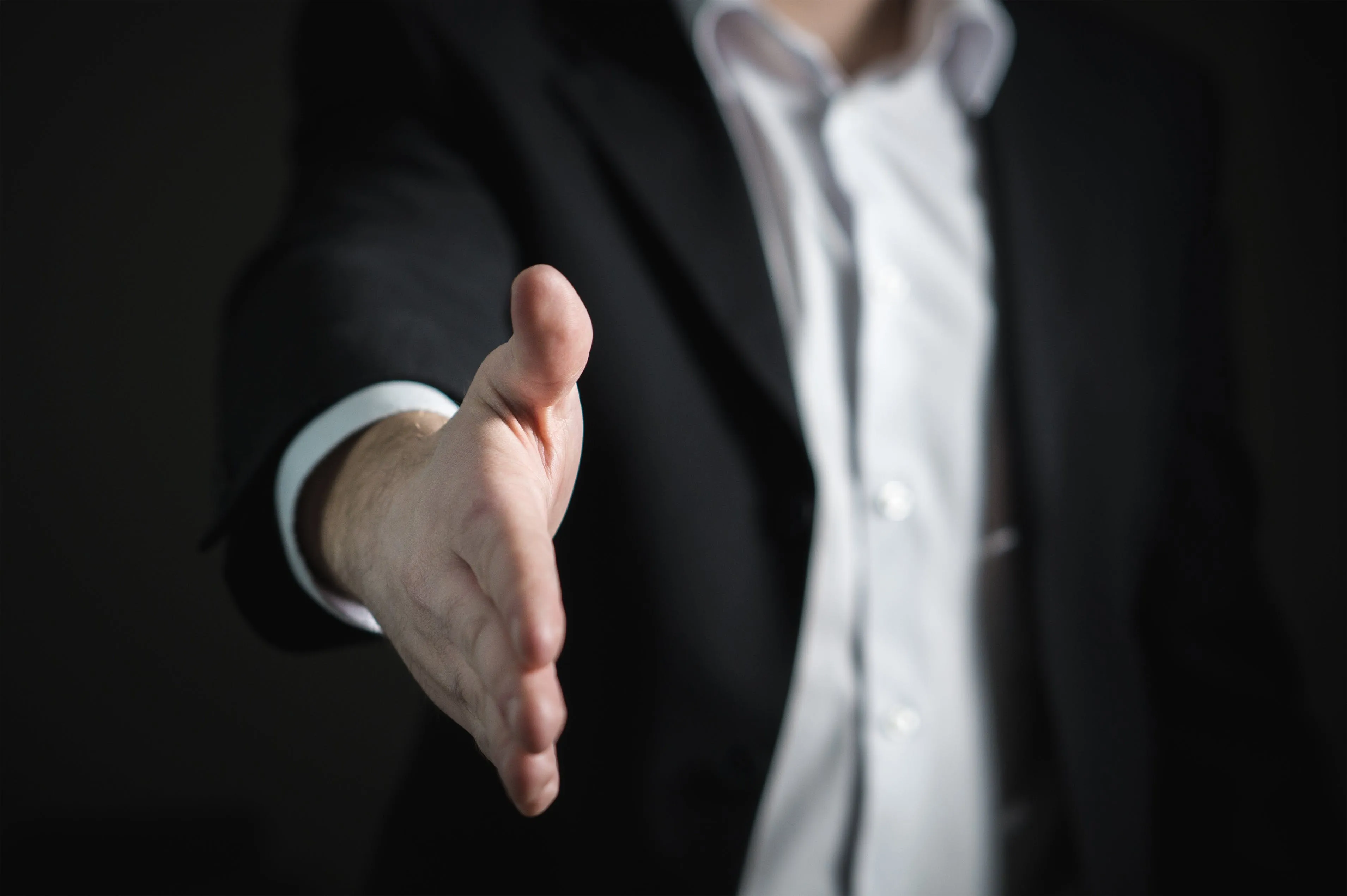 man holding out his hand for a hand shake